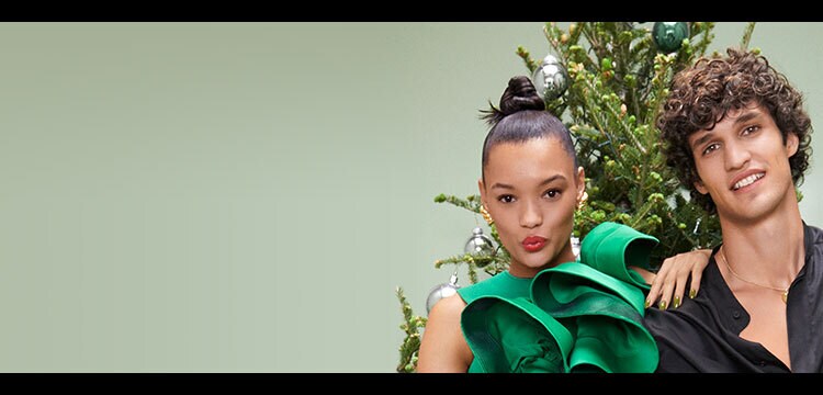 Origins models posing with holiday background