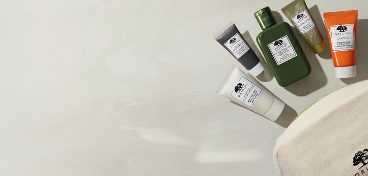 Origins best-seller discovery set with 5 pieces of skincare minis and ivory cosmetic bag spilled over